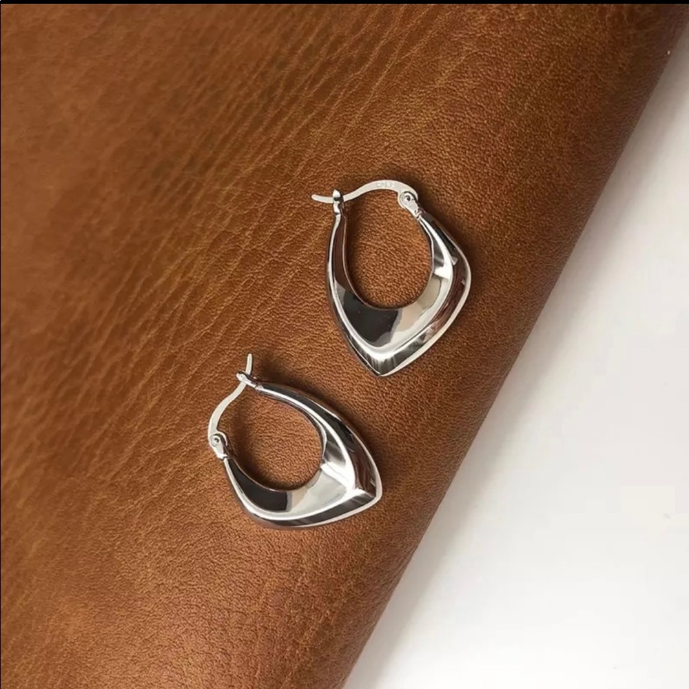 2/$30 925 Elegant asymmetrical silver hoops